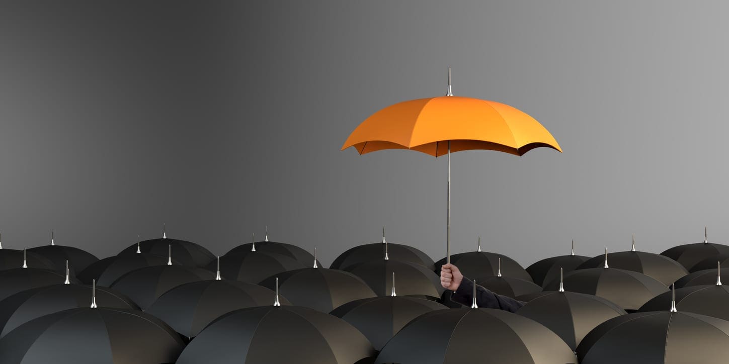 Orange Colored Umbrella Between The Black Umbrellas Income Protection